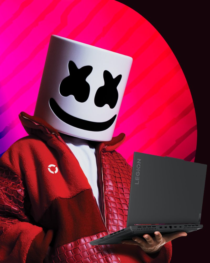 Marshmello in red, holding a Lenovo Legion laptop